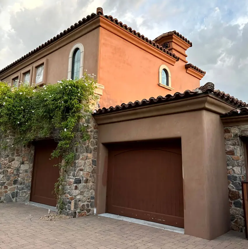 home-exterior-painting Freshly painted stone accents and arched garage doors phoenix az